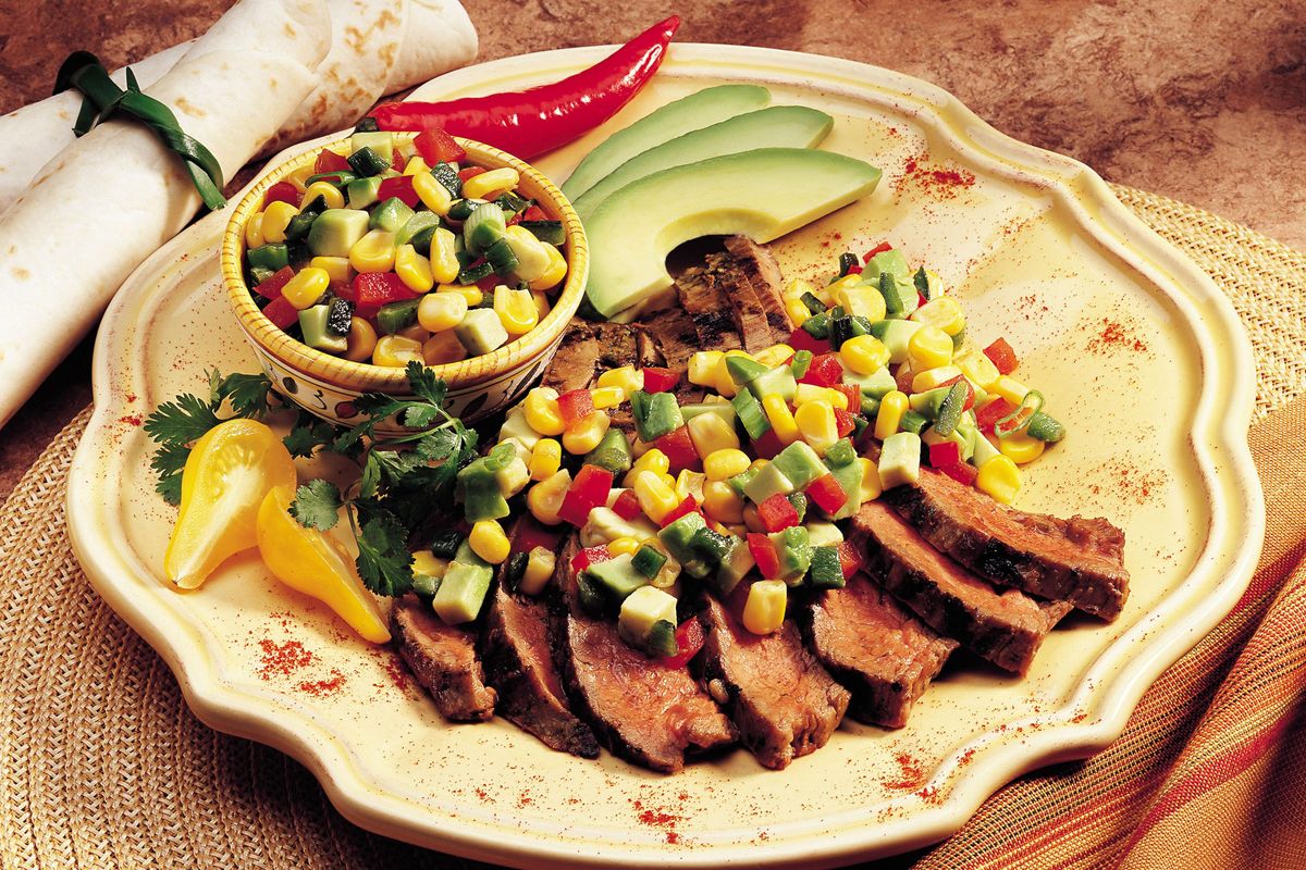 For Cinco de Mayo, California avocado corn salsa dresses up grilled meats or is a smoky and luxurious dip, as seen in this dish courtesy of chefs Mary Sue Milliken and Susan Feniger. (PRN)