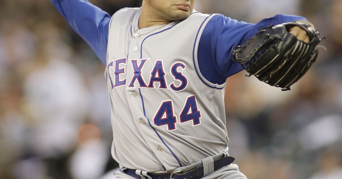 Texas Rangers pitcher Vicente Padilla wipes his face with his