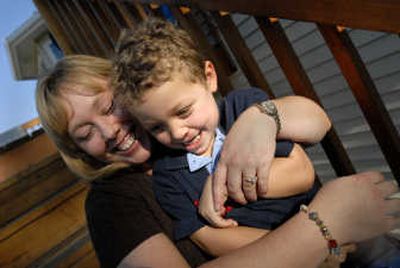 
Kari Almeida and her son Kolin, 4, share a moment after school on Tuesday. 
 (Brian Plonka / The Spokesman-Review)