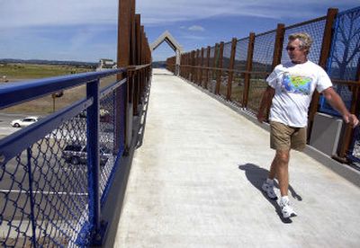 
Tom Hansen crosses Interstate 90 this week on the new pedestrian bridge connecting Liberty Lake and the Centennial Trail. 
 (Liz Kishimoto / The Spokesman-Review)