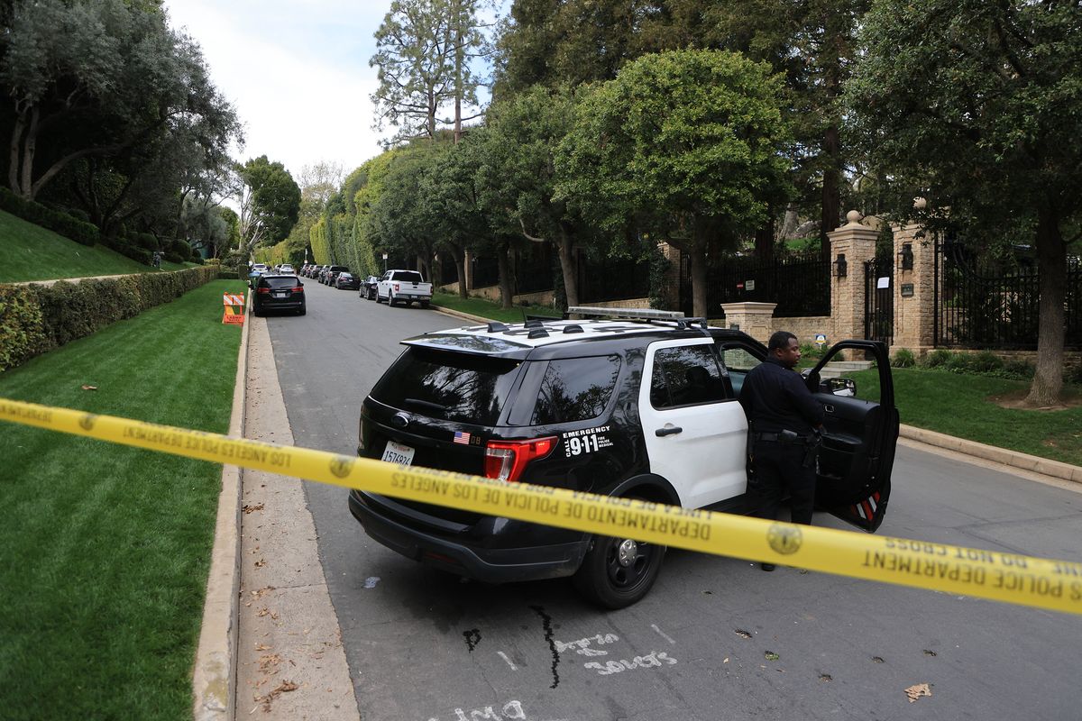 Police cars are seen behind caution tape outside the home of producer and musician Sean "Diddy" Combs in Los Angeles on Monday, March 25, 2024.   (David Swanson/AFP/GETTY IMAGES NORTH AMERICA/TNS)