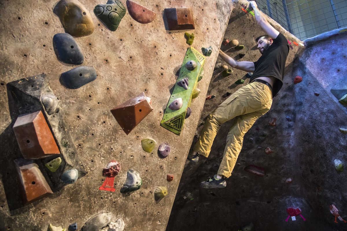 Quentin McQueen maneuvers his way on a bouldering wall on Feb. 22. 2018, at Wild Walls Climbing Gym.  (DAN PELLE)