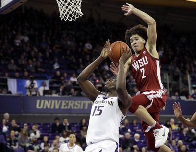 Washington State forward CJ Elleby  leaps to block a shot by Washington forward Noah Dickerson  during the first half Saturday, Jan. 5, 2019, in Seattle. (Ted S. Warren / AP)