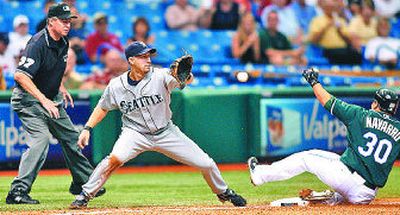 
M's Willie Bloomquist takes late throw on Dioner Navarro's triple. 
 (Associated Press / The Spokesman-Review)