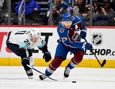 Colorado’s Nathan MacKinnon takes the puck up ice against Seattle’s Eeli Tolvanen during Game 5 Wednesday in Denver.  (Tribune News Service)