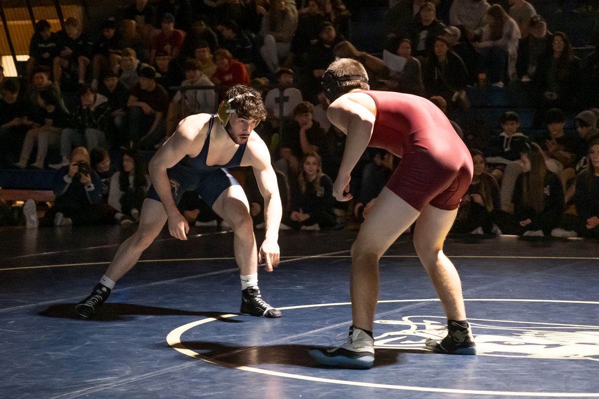 Mead’s Jeroen Smith, left, looks for an opening against University’s Bo Thompson during their 157-pound match in a Greater Spokane League showdown Thursday at Mead High School.  (Madison McCord/For The Spokesman-Review)