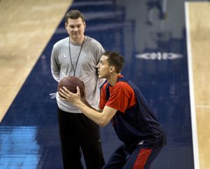 Gonzaga's Kyle Dranginis takes shooting instruction from coach Tommy Lloyd before practice on Monday. (Dan Pelle)