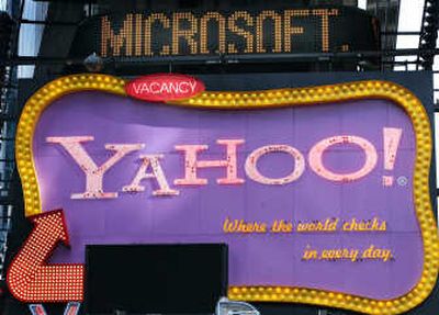 
A Times Square news ticker flashes a headline about Microsoft above a billboard for Yahoo  last May. 
 (Associated Press / The Spokesman-Review)