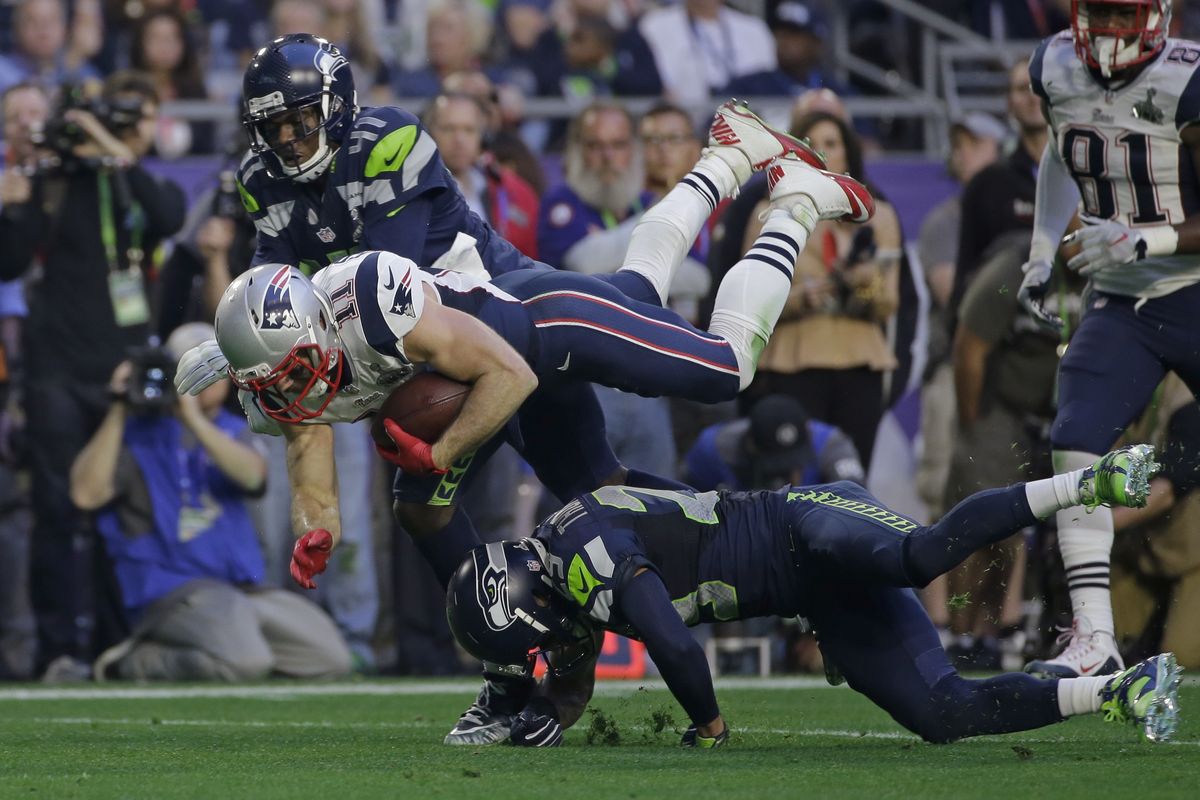 New England Patriots wide receiver Julian Edelman (11) leaps over Seattle Seahawks free safety Earl Thomas (29) during the first half of NFL Super Bowl XLIX football game Sunday, Feb. 1, 2015, in Glendale, Ariz. (Matt Slocum / Associated Press)
