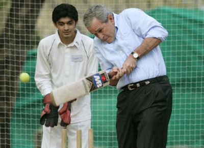 
President Bush bats during a cricket workshop at the U.S. Embassy in Islamabad, Pakistan, on Saturday on the last day of his tour of South Asia.
 (Associated Press / The Spokesman-Review)