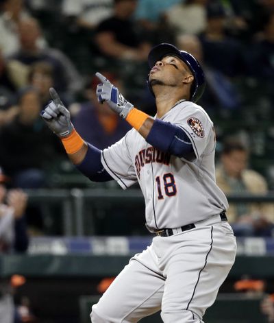 Houston Astros' Luis Valbuena points skyward as he crosses home on his home run against the Seattle Mariners in the eighth inning of a baseball game Monday, April 20, 2015, in Seattle. (Associated Press)