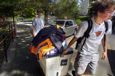 
Josh Adams of Spokane gets another load out of the car Tuesday while moving into his dorm at WSU. Also helping are his brother Jared, left, and his mom Becky Byerly- Adams. 
 (Christopher Anderson/ / The Spokesman-Review)