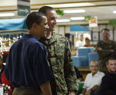 President-elect Barack Obama poses for a photo with an unidentified soldier as they eat Christmas dinner at Marine Corp Base Hawaii in Kailua, Hawaii, on Thursday.  (Associated Press / The Spokesman-Review)