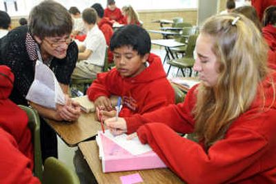 
Teacher Penny Jansen helps eighth-grade students Ernhel Tatunay, middle, and Lexi Tiffany diagram a sentence   Nov. 8 at St. Joseph's Catholic School in Kennewick. Associated Press
 (Associated Press / The Spokesman-Review)