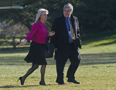 In this Jan. 26, 2017, photo White House counselor Kellyanne Conway, left, and senior adviser Steve Bannon, right, walk on the South Lawn of the White House in Washington, after returning via Marine One from a trip to Philadelphia with President Donald Trump. (Susan Walsh / Associated Press)