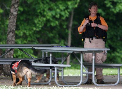 Paula Chambers, a civilian volunteer, rests Saturday after searching for and finding a body in the area near where University of Georgia professor George Zinkhan’s Jeep was found a week ago.  (Associated Press / The Spokesman-Review)