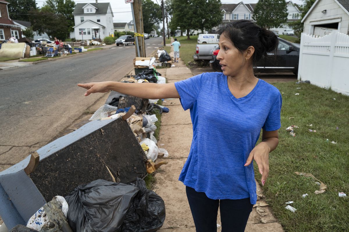 Flor Sosa stands near the home she shares with her sister in Manville, N.J., Sunday, Sept. 5, 2021, as she describes how the basement walls crumbled while they and others were in the house as the remnants of Hurricane Ida inundated the region.  (Craig Ruttle)