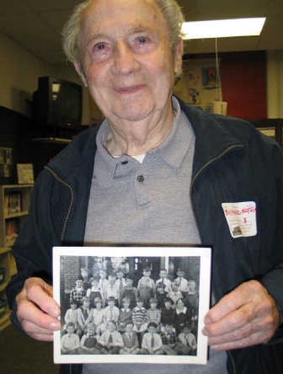
Bill Harrington displays one of his class pictures. He graduated from the school as an eighth-grader in 1929. Harrington appears second from the right in the bottom row of students in the class photo. 
 (Lisa Leinberger / The Spokesman-Review)
