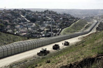 
This border fence runs along the U.S.-Mexico border at San Diego. While crime is lower in nearby California neighborhoods, critics say it increases the likelihood migrants will die in the desert. 
 (Associated Press / The Spokesman-Review)