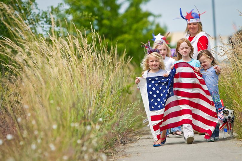In this 2012 Coeur d'Alene Press file photo, Joely Gardiner, left, Emma Marks and Ellie Deaton lead a patriotic parade as they march along a overgrown section of sidewalk in Coeur d'Alene. (Jerome A Pollos/Coeur d'Alene Press file photo) (Jerome Pollos)
