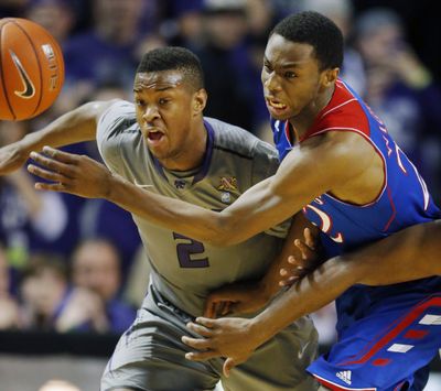 Kansas State’s Marcus Foster, left, and Kansas’ Andrew Wiggins chase after a loose ball in the first half. (Associated Press)