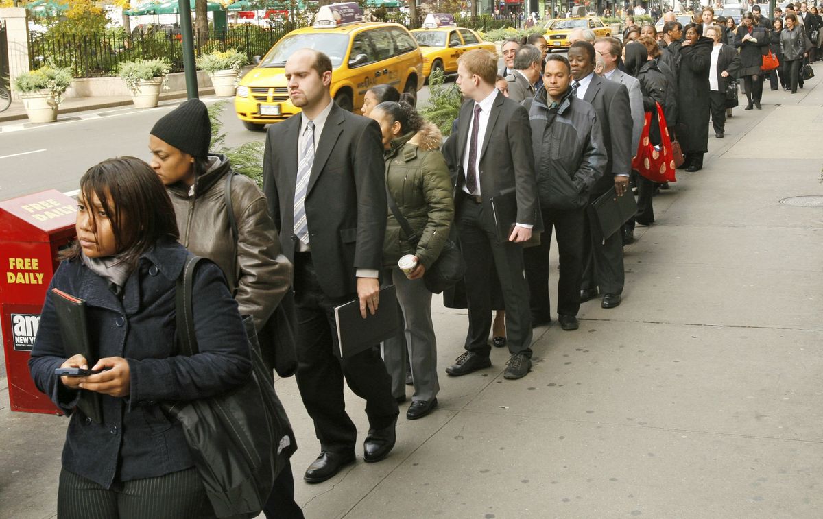 Job seekers wait in a long line along Broadway to enter a job fair sponsored by the Web site Monster.com. Retailers say they have seen a surge in the number of applicants seeking holiday work as the sector is shrinking because of store closures and liquidations. (The Spokesman-Review)