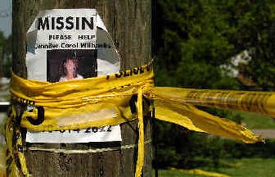 
A days-old missing-person sign showing Jennifer Wilbanks hangs on a utility pole, wrapped with police tape, outside John Mason's home in Duluth, Ga., on Sunday, two days after Wilbanks, Mason's fiancee, turned up in New Mexico.  
 (Associated Press / The Spokesman-Review)