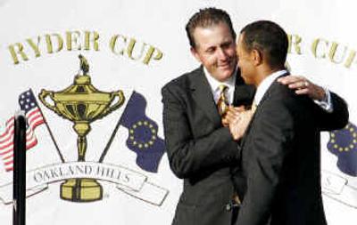 
Phil Mickelson and Tiger Woods, who have never been great pals off the course, shake hands as Ryder Cup teammates Thursday.
 (Associated Press / The Spokesman-Review)