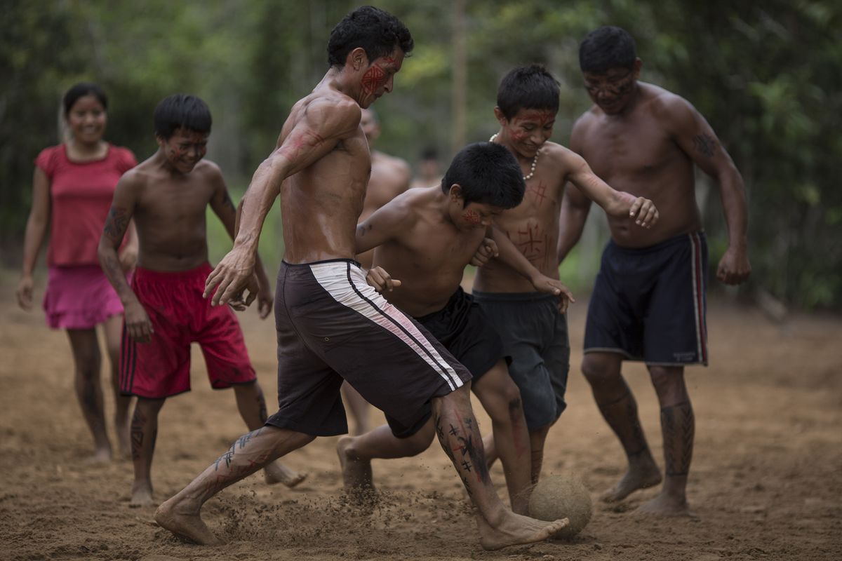 Boys play soccer in the Tatuyo indigenous community near Manaus, Brazil. Tourists often take part in coed matches. (Associated Press)