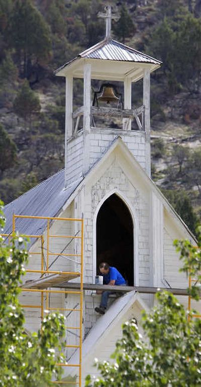 
Dave Wilper works at painting the window at the front of Our Lady of Tears Catholic Church in Silver City, Idaho.Associated Press
 (Associated Press / The Spokesman-Review)
