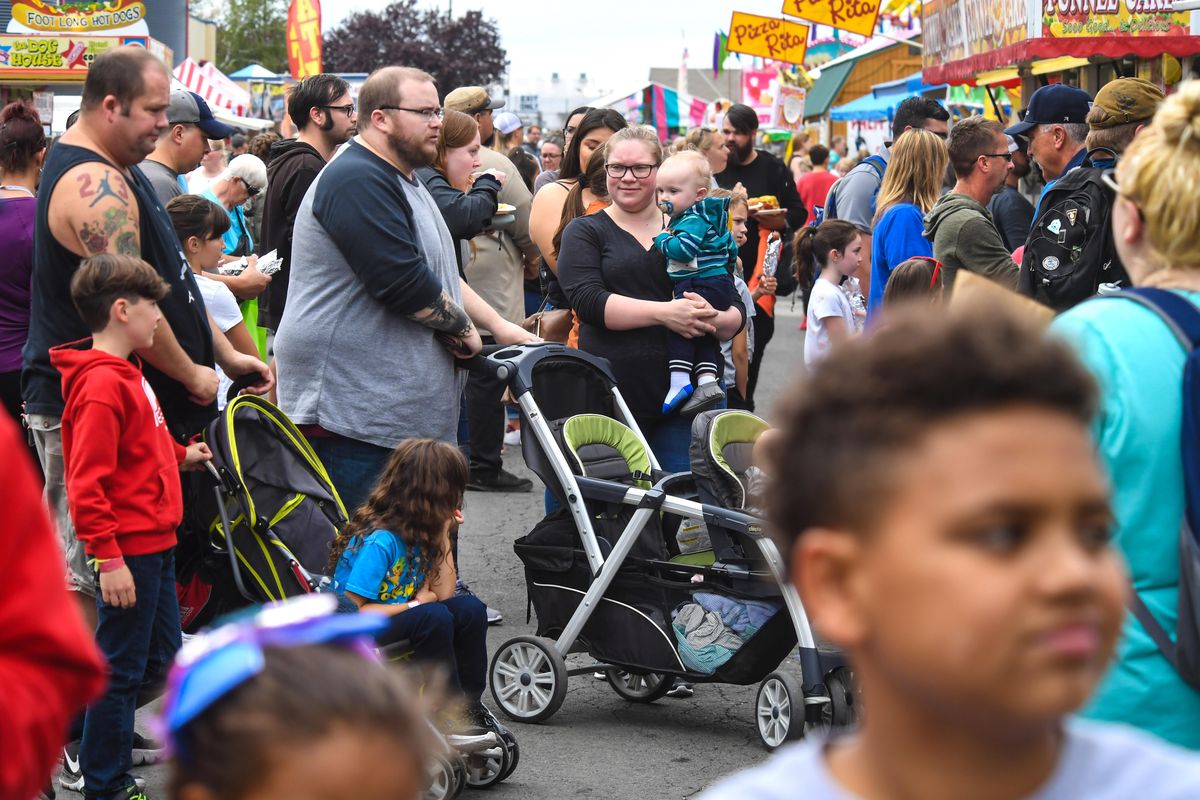 Huge crowds pack the food court area outside a corn dog booth Saturday, Sept. 14, 2019, at the Spokane County Interstate Fair. (Dan Pelle / The Spokesman-Review)