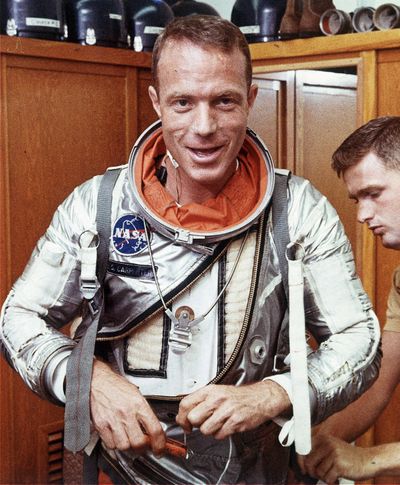 Astronaut Scott Carpenter has his space suit adjusted by a technician in Cape Canaveral, Fla., in August 1962. Carpenter was the second American to orbit Earth. (Associated Press)