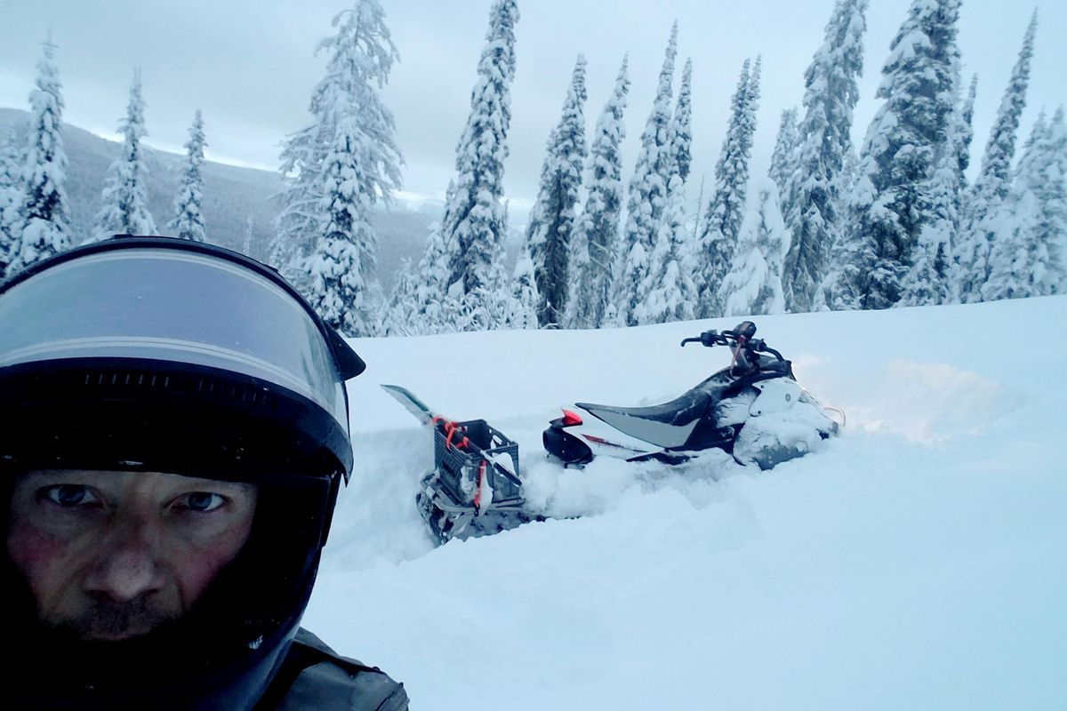 Justin Webb snowmobiles through deep winter snow during a 14-hour day to check his 70-mile wolf trapline. Courtesy photo (COURTESY / COURTESY)