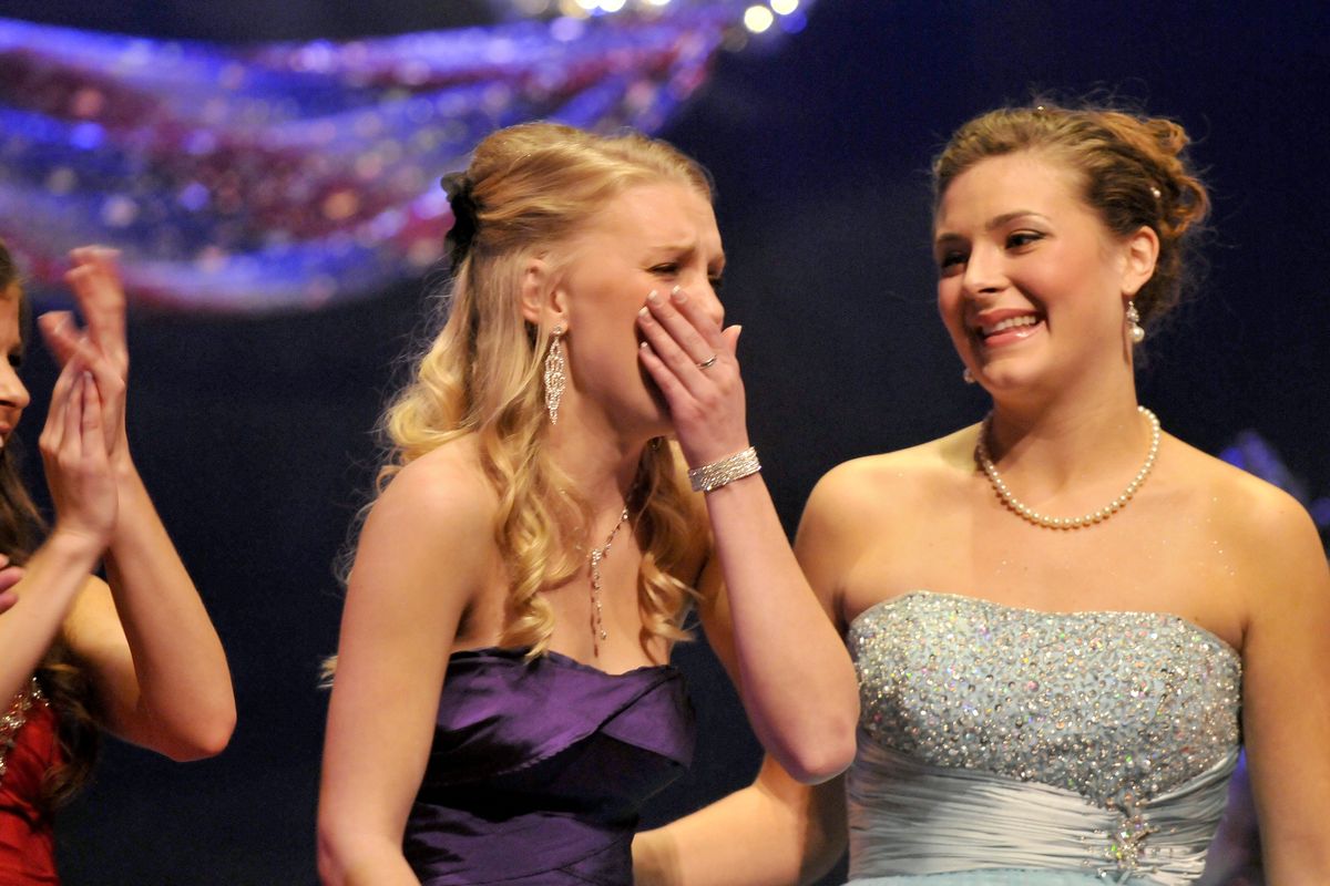 Brett Rountree is overcome with emotion as she is announced as the 2013 Lilac queen on Sunday at the Bing Crosby Theater. Emily Staker, left, and Katie Heitkemper, right, look on. (Jesse Tinsley)