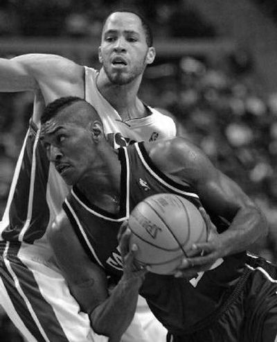 
Kings forward Ron Artest, foreground, drives on Detroit Pistons forward Tayshaun Prince. 
 (Associated Press / The Spokesman-Review)