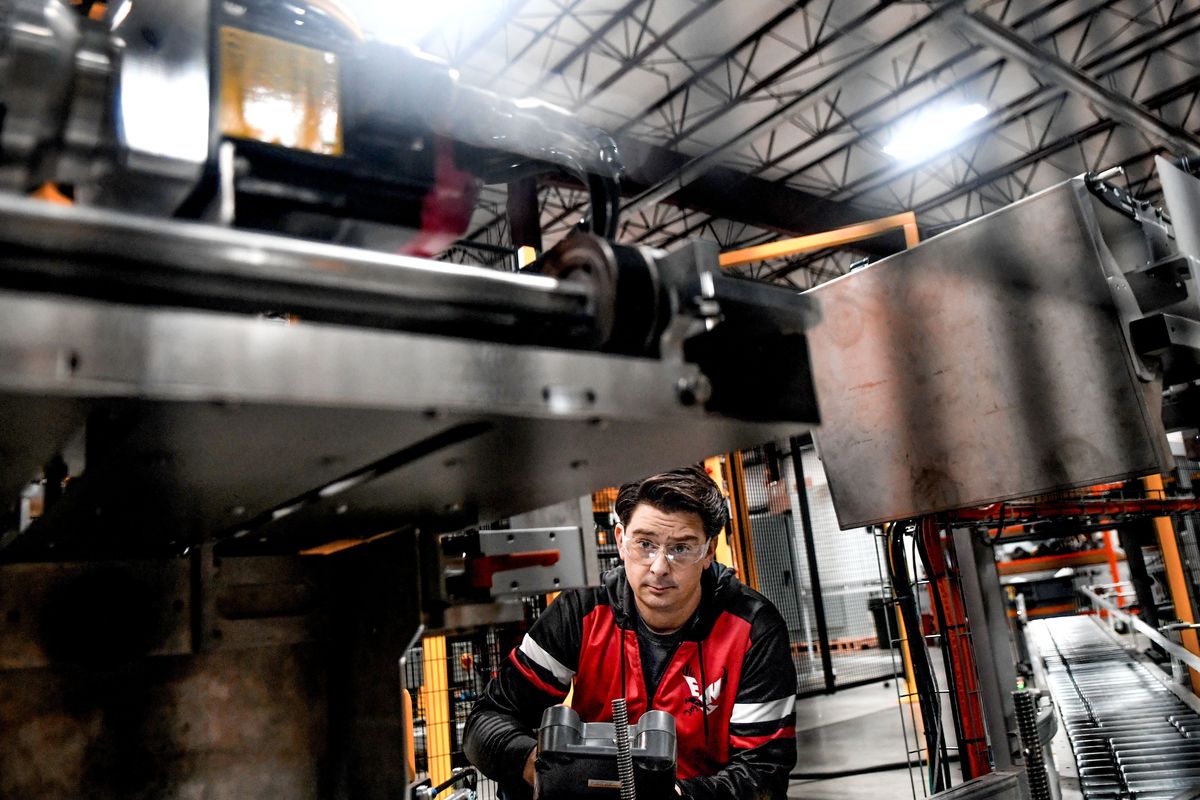 Controls engineer Ken Lauritzen programs the vertical case packer robot on earlier this year at Pearson Packaging Systems in Spokane.  (KATHY PLONKA/THE SPOKESMAN-REVIEW)