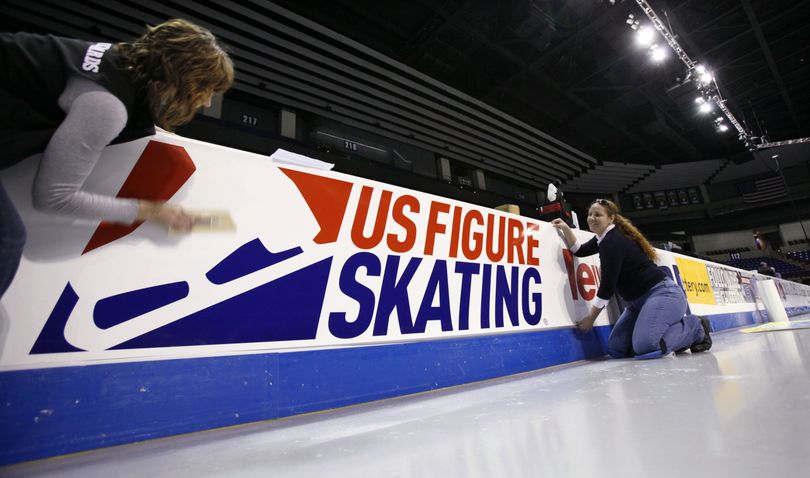 Heather Roderick, left, and Nora McKeon place signs on the boards in preparation for the US figure skating championships, Wednesday, Jan. 13, 2010, in Spokane, Wash. The event begins Friday, Jan. 15. (Elaine Thompson / Associated Press)