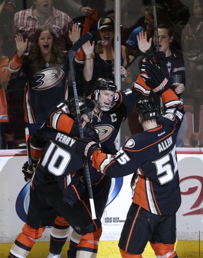 Despite taking a slap shot to the face in Game 1, Anaheim’s Getzlaf (center) returned in Game 2 and tallied one goal, one assist. (Associated Press)