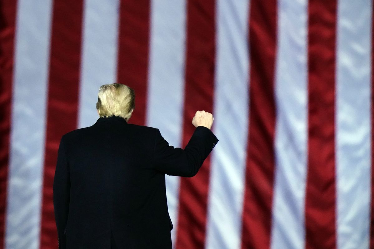 President Donald Trump gestures at a campaign rally in support of U.S. Senate candidates Sen. Kelly Loeffler, R-Ga., and David Perdue in Dalton, Ga., Monday, Jan. 4, 2021.  (Brynn Anderson)