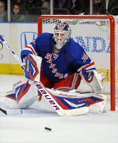 Rangers goaltender Henrik Lundqvist makes one of his 20 saves during the third period of New York’s victory over New Jersey. (Associated Press)
