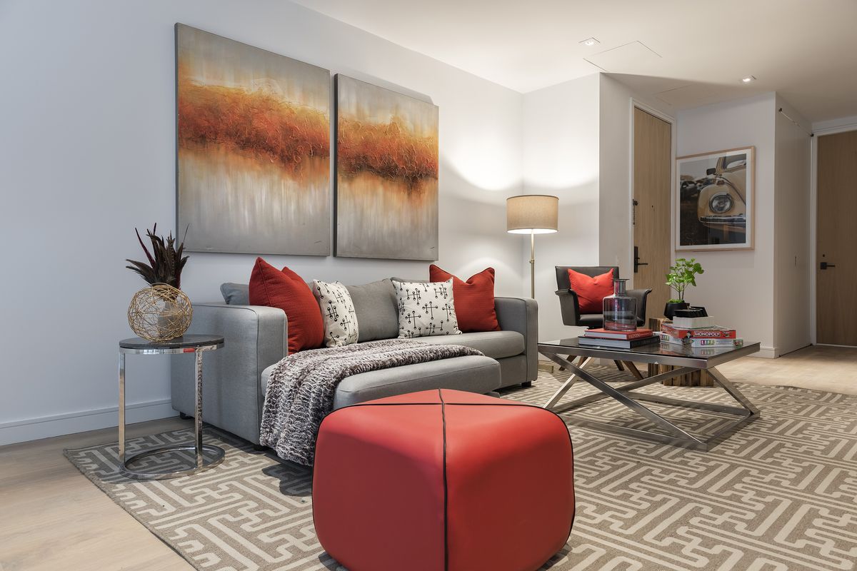 A small-scale sectional sofa with an ottoman creates a space with the appropriate scale in this family-friendly room.  (Design Recipes)
