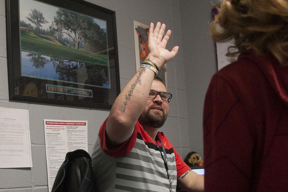 Counselor Jared Kuhn of Willard Elementary’s courtesy club high-fives Riley Berry on Wednesday, Dec. 19, 2018. Their motto is “Look good, feel good, to do good.” The students learn about good manners and respect and the importance of dressing well and more. (Kathy Plonka / The Spokesman-Review)