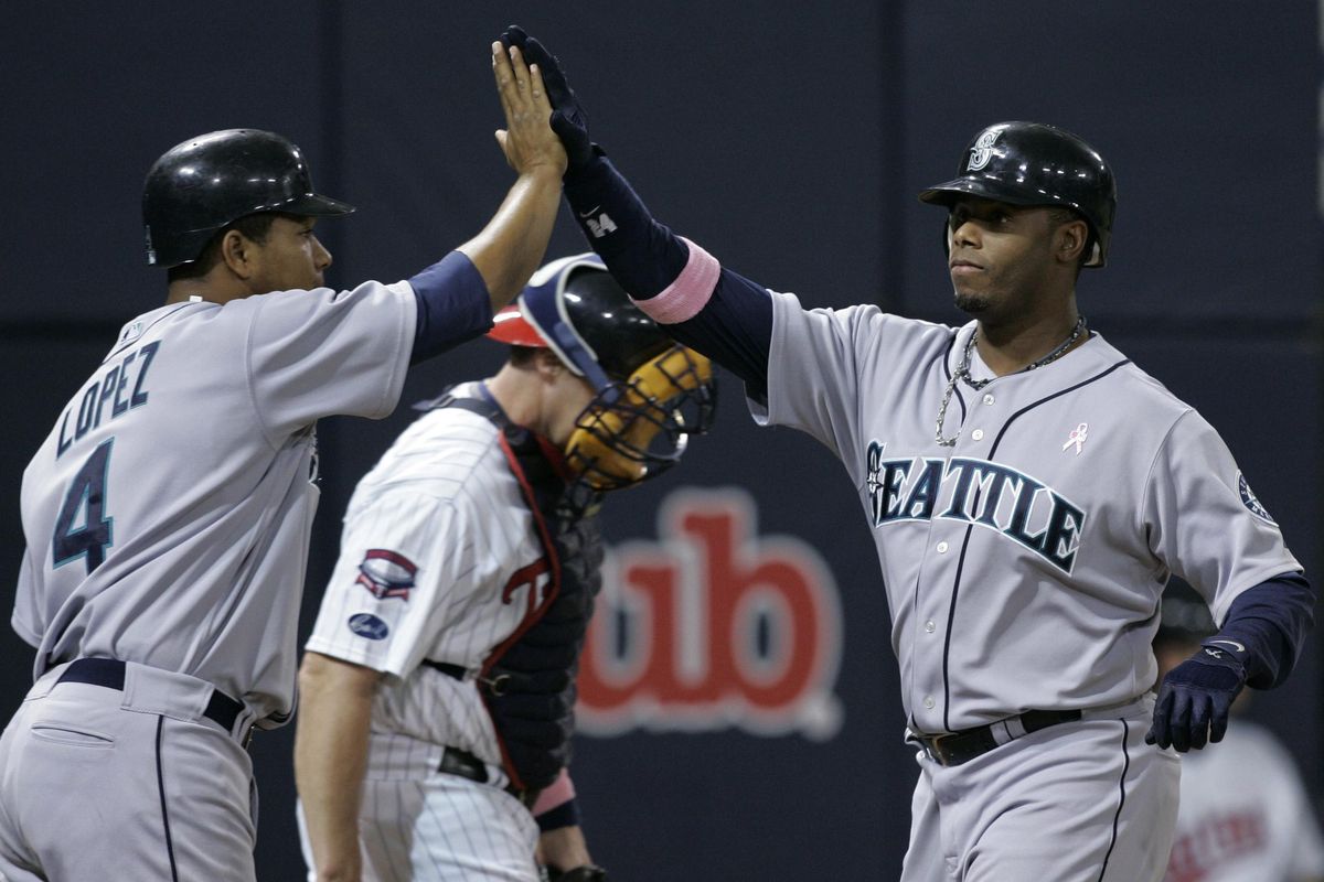 Ken Griffey Jr., right, received 99.3 percent of the votes on his hall of fame ballot. (Jim Mone / Associated Press)