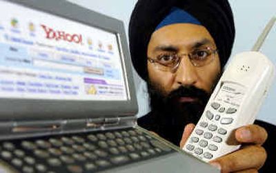 
Datawind CEO Suneet Singh Tuli displays his pocket surfer, left, which controls his Internet telephone in Toronto. Tuli is in the Voice-over-Internet vanguard, relying ever more on a technology that is transforming what it means to make a phone call. 
 (Associated Press / The Spokesman-Review)