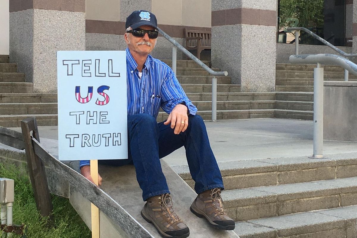 Mike Mannshardt, 70, a retired teacher from Pittsboro, N.C., waits to hear from speakers at an anti-Trump rally in Raleigh on Saturday. Mannshardt and other demonstrators want Trump to release his income tax returns. (Emery P. Dalesio / Associated Press)