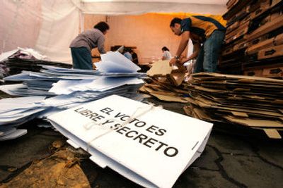 
Voting officials stack ballot boxes from Sunday's election at an electoral district office in Mexico City on Monday. The sign on the empty box reads 