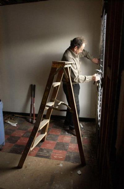 
Roger Crawford, a Millwood Presbyterian Church member and retired business owner, dismantles a door at the old Millwood Post Office. He and other church members have volunteered to help the church remodel the building and transform it into a youth center. 
 (J. BART RAYNIAK / The Spokesman-Review)