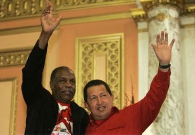 
Venezuelan President Hugo Chavez, right, and actor Danny Glover wave to a crowd gathered at the Mount Olivet Baptist Church in the Harlem neighborhood of New York on Thursday. 
 (Associated Press / The Spokesman-Review)