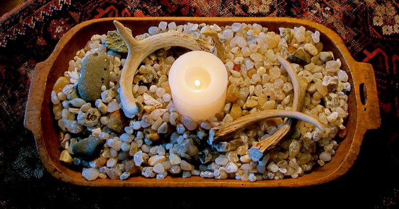 An antique dough bowl, filled with natural objects such as stones and antlers, makes an pretty setting for a candle. (Cheryl-Anne Millsap / Photo by Cheryl-Anne Millsap)