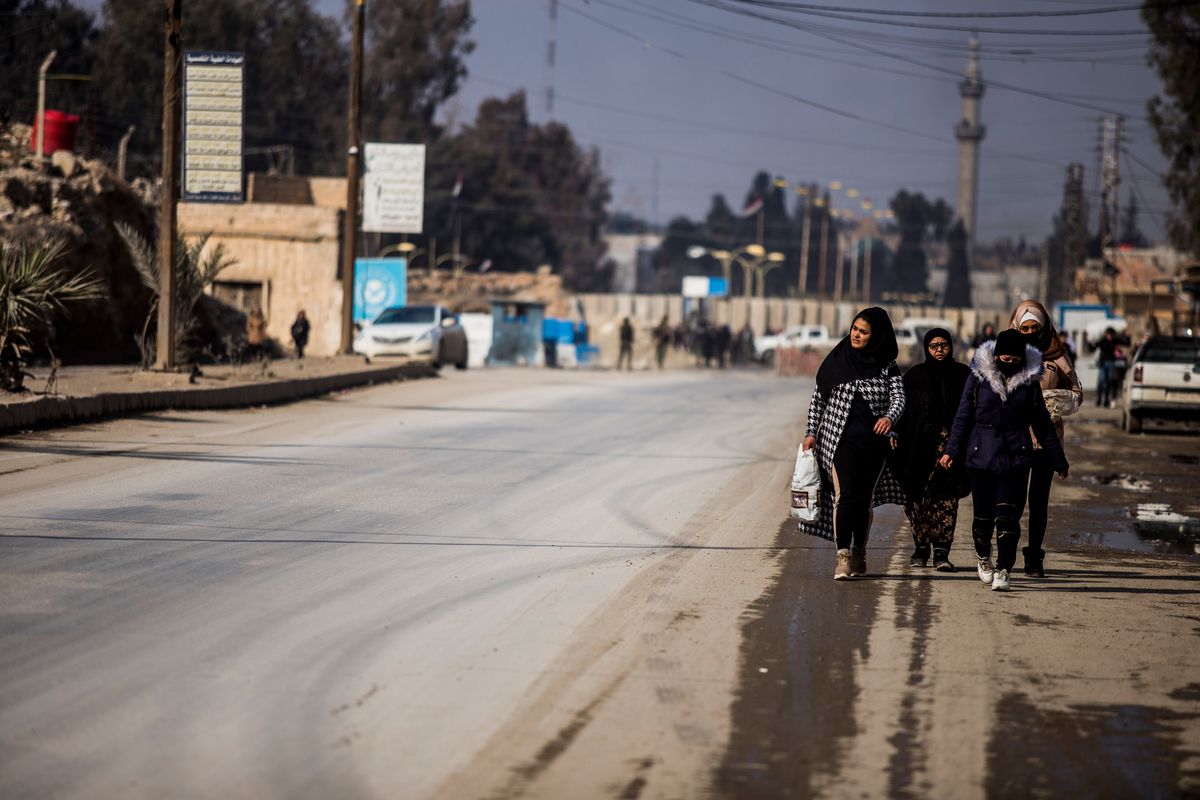 Civilians return to the city after fighting subsideds in Hassakeh, Syria, Sunday, Jan. 30, 2022. The Islamic State group